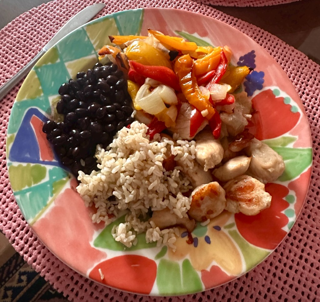 Plate with chicken breast, brown rice, black beans, and bell peppers